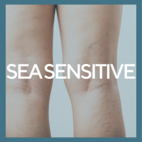 A soft blue background with the words Sea Sensitive across the legs of a woman with varicose veins